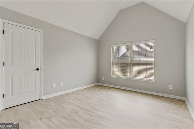 766 Chapman St, Jonesboro, GA 30238 - unfurnished room featuring vaulted ceiling, light wood-style floors, and baseboards