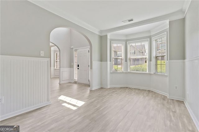 766 Chapman St, Jonesboro, GA 30238 - spare room with arched walkways, light wood finished floors, wainscoting, and ornamental molding