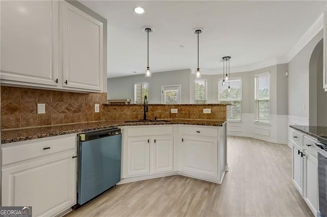766 Chapman St, Jonesboro, GA 30238 - kitchen featuring dishwashing machine, a sink, light wood-style flooring, white cabinets, and a peninsula