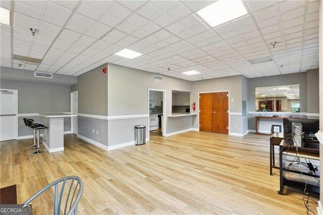 377 Ralph Mcgill Blvd NE Unit C, Atlanta, GA 30312 - unfurnished living room featuring light wood-type flooring and a paneled ceiling