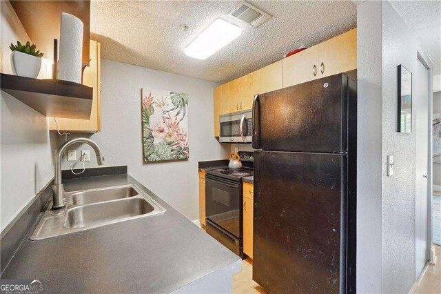 377 Ralph Mcgill Blvd NE Unit C, Atlanta, GA 30312 - kitchen featuring black appliances, a textured ceiling, a textured wall, and open shelves