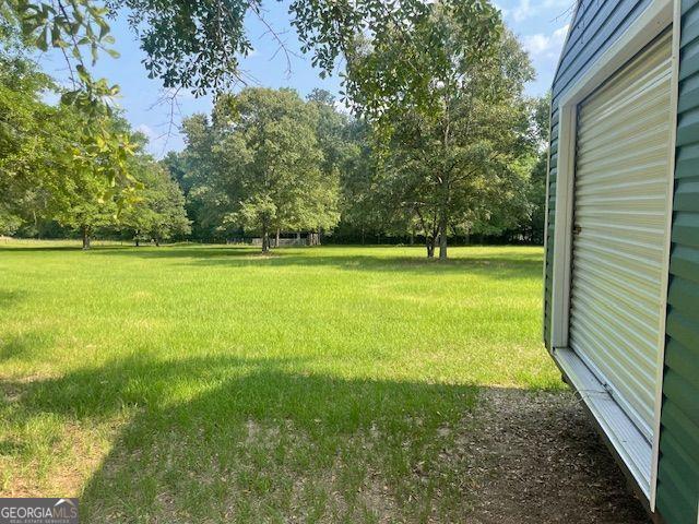 1167 Underwood, Sparta, GA 31087 - view of grassy yard featuring view of wooded area