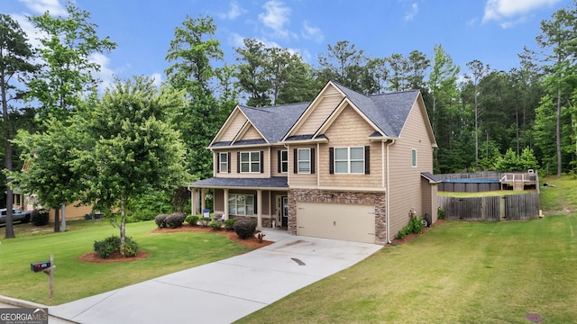 572 Boulder View Pkwy, Dallas, GA 30157 - craftsman-style home featuring stone siding, driveway, an attached garage, covered porch, and roof with shingles