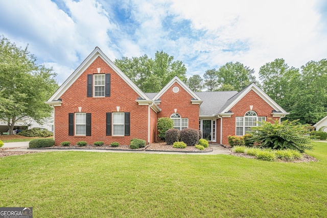 2870 Jay Oak Dr, Dacula, GA 30019 - traditional-style house featuring brick siding and a front lawn