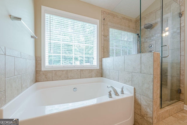 2870 Jay Oak Dr, Dacula, GA 30019 - full bath featuring a garden tub, a shower stall, and tile walls