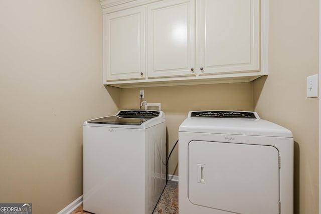 2870 Jay Oak Dr, Dacula, GA 30019 - washroom featuring independent washer and dryer, cabinet space, and baseboards