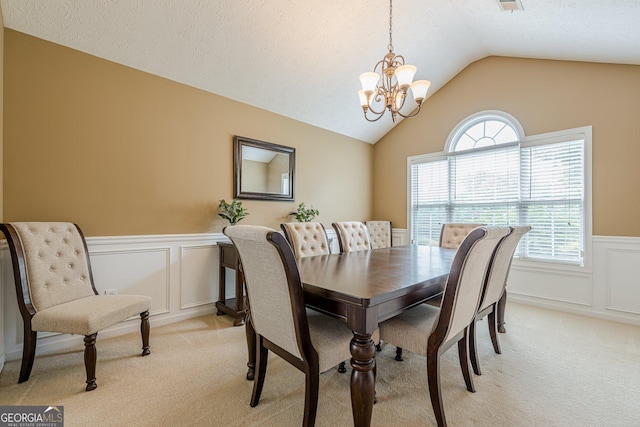 2870 Jay Oak Dr, Dacula, GA 30019 - dining room featuring light colored carpet, a chandelier, wainscoting, a decorative wall, and lofted ceiling