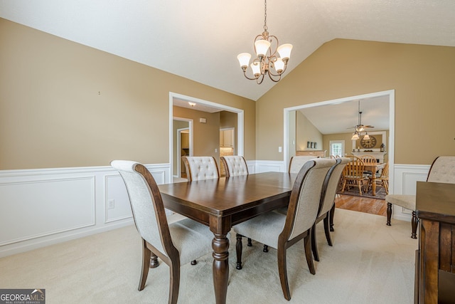 2870 Jay Oak Dr, Dacula, GA 30019 - dining area with a chandelier, wainscoting, vaulted ceiling, light carpet, and a decorative wall