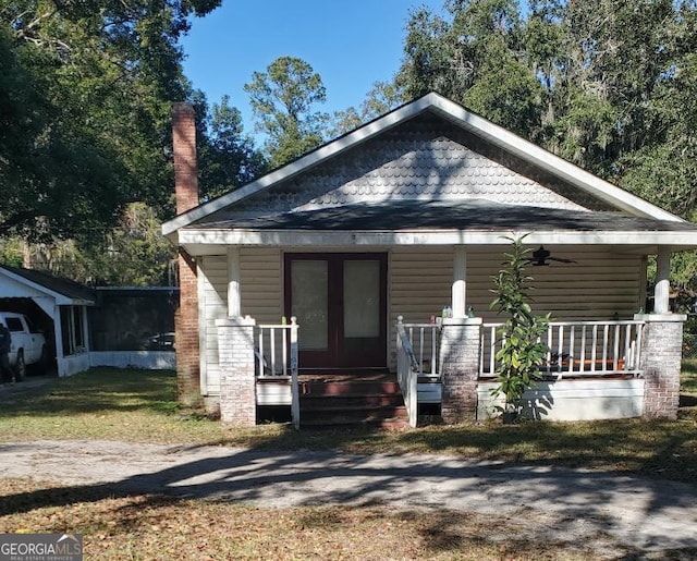 228 E Hilton St, Kingsland, GA 31548 - bungalow-style house featuring a porch, ceiling fan, and a chimney
