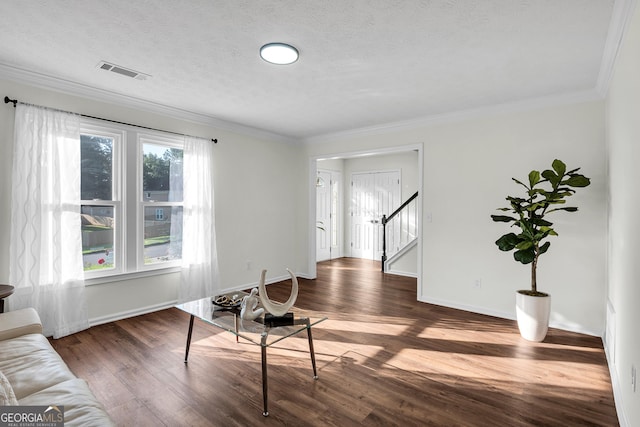 1172 Rockmart Cir NW, Kennesaw, GA 30144 - living area featuring dark wood-type flooring, stairway, ornamental molding, and a textured ceiling