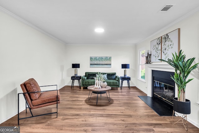 1172 Rockmart Cir NW, Kennesaw, GA 30144 - sitting room with crown molding, a glass covered fireplace, wood finished floors, and recessed lighting