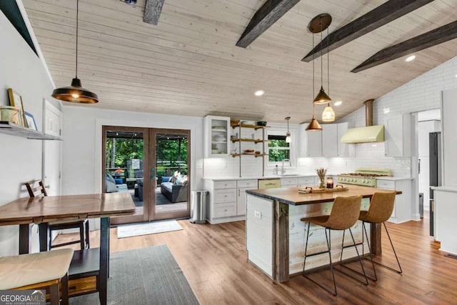 14905 Thompson Rd, Milton, GA 30004 - kitchen with french doors, wall chimney exhaust hood, open shelves, decorative backsplash, and white cabinetry