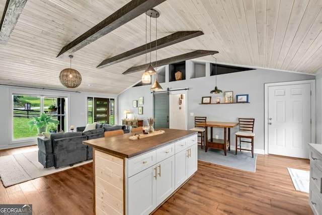 14905 Thompson Rd, Milton, GA 30004 - kitchen featuring butcher block counters, a barn door, wooden ceiling, open floor plan, and wood finished floors