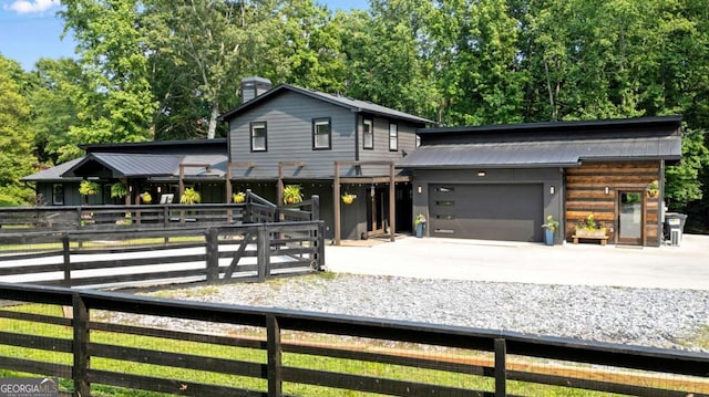 14905 Thompson Rd, Milton, GA 30004 - view of front of home featuring driveway, an attached garage, and a chimney