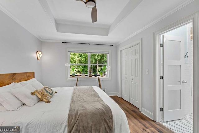 14905 Thompson Rd, Milton, GA 30004 - bedroom featuring wood finished floors, a tray ceiling, a closet, ornamental molding, and ceiling fan