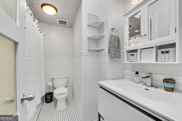 14905 Thompson Rd, Milton, GA 30004 - full bathroom with toilet, vanity, tile walls, wainscoting, and a shower with curtain