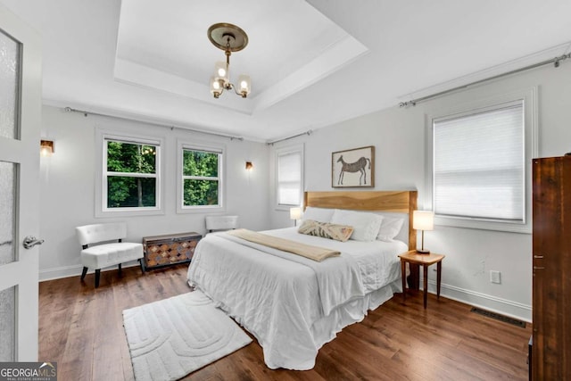 14905 Thompson Rd, Milton, GA 30004 - bedroom with wood finished floors, a tray ceiling, a chandelier, and baseboards