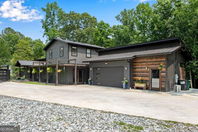 14905 Thompson Rd, Milton, GA 30004 - modern home with driveway, a garage, and metal roof