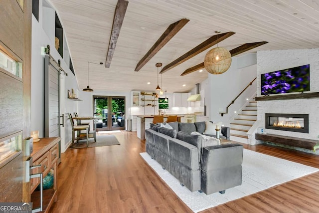 14905 Thompson Rd, Milton, GA 30004 - living area with light wood-style floors, a large fireplace, stairs, french doors, and recessed lighting