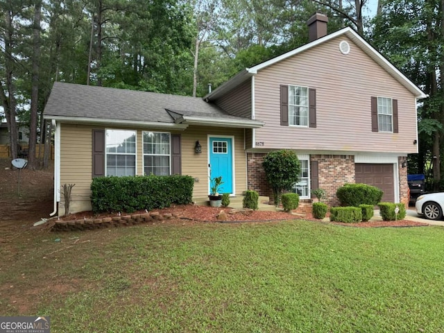 4678 Browns Mill Ferry Rd, Lithonia, GA 30038 - split level home featuring an attached garage, a chimney, a front lawn, brick siding, and roof with shingles