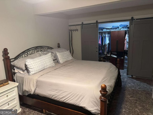 4678 Browns Mill Ferry Rd, Lithonia, GA 30038 - bedroom with a barn door, a closet, dark colored carpet, and a walk in closet