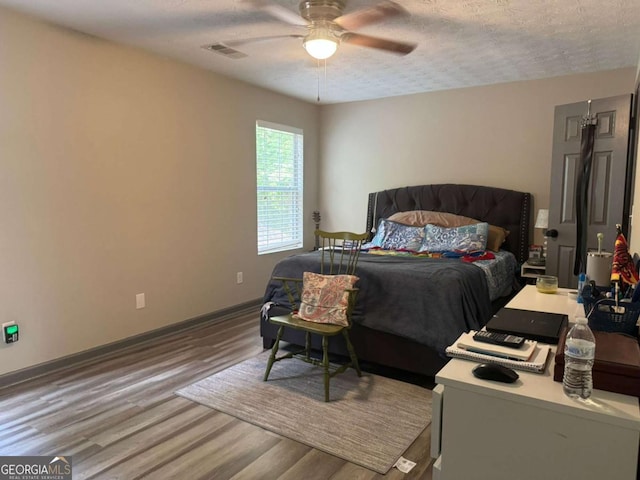 4678 Browns Mill Ferry Rd, Lithonia, GA 30038 - bedroom with wood finished floors, baseboards, a textured ceiling, and ceiling fan