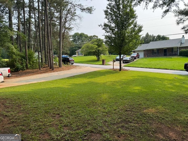 4678 Browns Mill Ferry Rd, Lithonia, GA 30038 - view of green lawn featuring concrete driveway and a garage