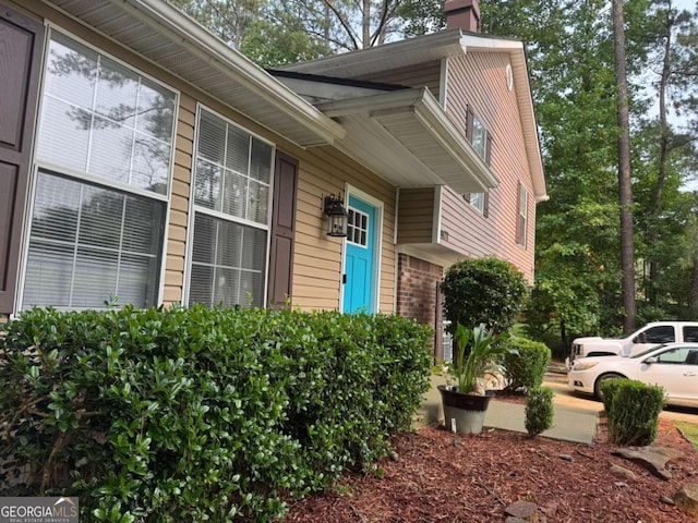 4678 Browns Mill Ferry Rd, Lithonia, GA 30038 - view of exterior entry with a chimney