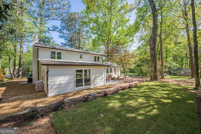 4446 Huntington Cir, Atlanta, GA 30338 - back of house featuring a yard and a patio