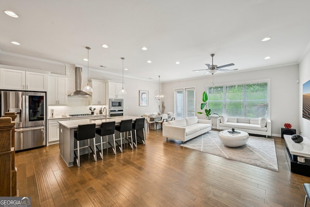 20056 Windalier Way, Roswell, GA 30076 - kitchen with appliances with stainless steel finishes, wall chimney exhaust hood, open floor plan, light countertops, and a kitchen breakfast bar