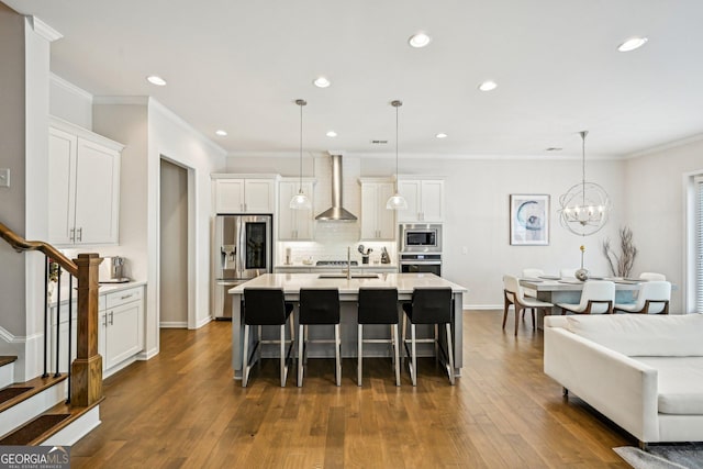 20056 Windalier Way, Roswell, GA 30076 - kitchen featuring stainless steel appliances, wall chimney range hood, a breakfast bar area, white cabinets, and light countertops