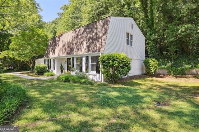 4234 Long Branch Ct, Brookhaven, GA 30319 - view of front facade with a gambrel roof, a shingled roof, and a front yard
