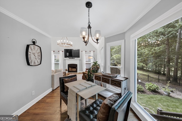 3535 Fairgreen Ct, Douglasville, GA 30135 - dining area with a chandelier, crown molding, baseboards, a fireplace, and wood finished floors