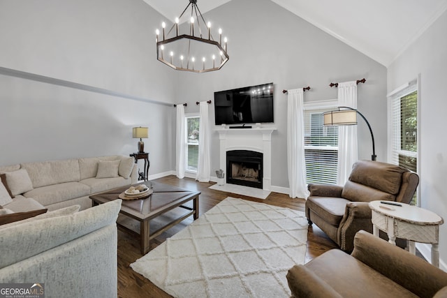 3535 Fairgreen Ct, Douglasville, GA 30135 - living area featuring high vaulted ceiling, a fireplace with flush hearth, a chandelier, dark wood-style flooring, and baseboards