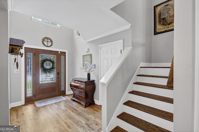 3535 Fairgreen Ct, Douglasville, GA 30135 - entrance foyer featuring stairway, light wood-style floors, baseboards, and crown molding