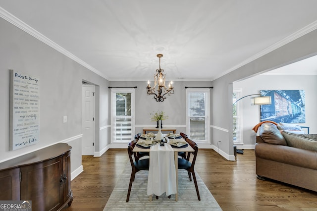 3535 Fairgreen Ct, Douglasville, GA 30135 - dining area featuring a chandelier, plenty of natural light, dark wood-type flooring, and crown molding