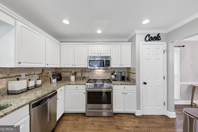 3535 Fairgreen Ct, Douglasville, GA 30135 - kitchen with stainless steel appliances, decorative backsplash, dark wood-type flooring, white cabinets, and ornamental molding