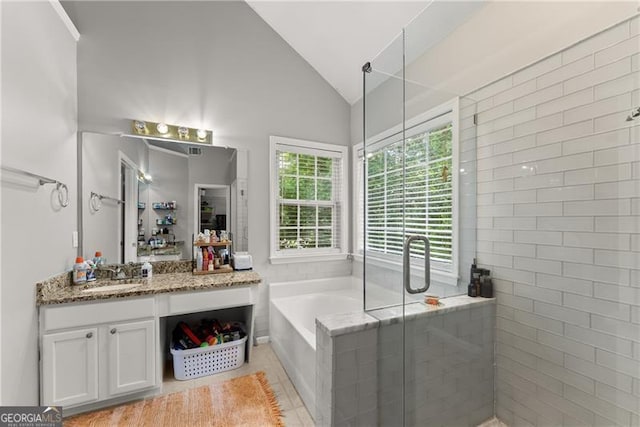 5510 Pilgrim Point Ext, Cumming, GA 30041 - bathroom featuring vanity, a garden tub, vaulted ceiling, a shower stall, and tile patterned flooring
