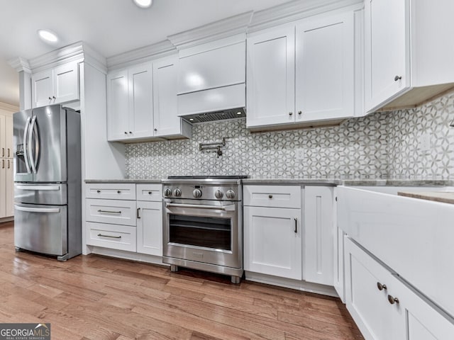 646 Darlington Cir NE, Atlanta, GA 30305 - kitchen featuring appliances with stainless steel finishes, white cabinetry, light wood-style floors, backsplash, and recessed lighting