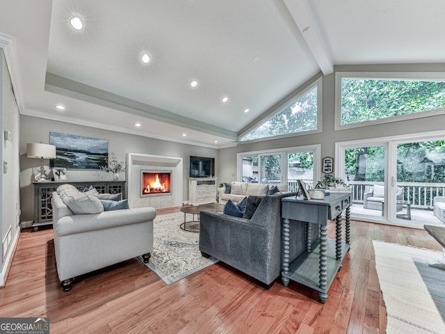 646 Darlington Cir NE, Atlanta, GA 30305 - living room with beam ceiling, light wood finished floors, a warm lit fireplace, recessed lighting, and high vaulted ceiling