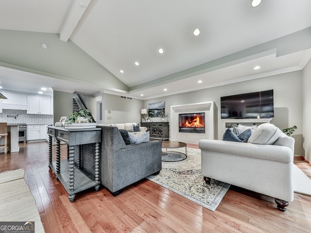 646 Darlington Cir NE, Atlanta, GA 30305 - living area with stairs, a glass covered fireplace, light wood-style flooring, recessed lighting, and ornamental molding