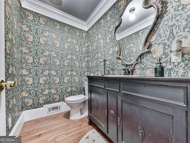 646 Darlington Cir NE, Atlanta, GA 30305 - half bath featuring wallpapered walls, crown molding, wood finished floors, toilet, and vanity