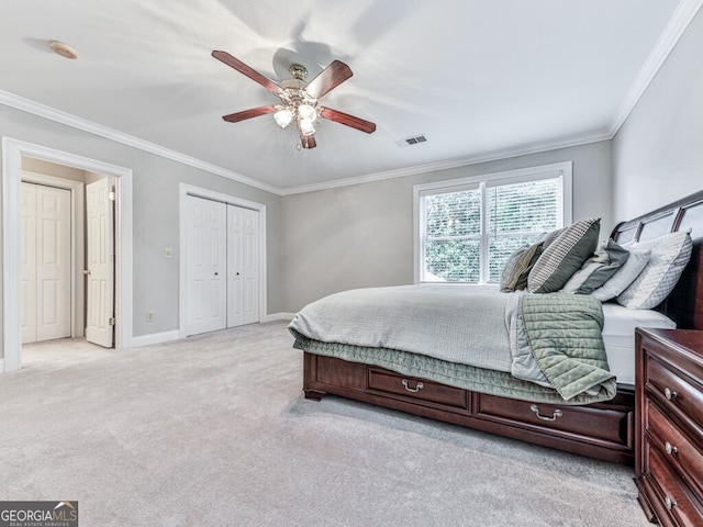 646 Darlington Cir NE, Atlanta, GA 30305 - bedroom with light colored carpet, crown molding, baseboards, a ceiling fan, and a closet