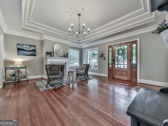 646 Darlington Cir NE, Atlanta, GA 30305 - entryway featuring a raised ceiling, wood finished floors, a chandelier, a fireplace with flush hearth, and ornamental molding