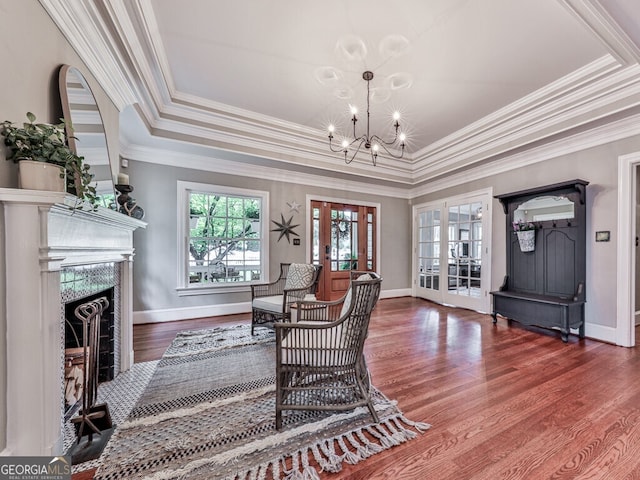 646 Darlington Cir NE, Atlanta, GA 30305 - living room featuring a chandelier, wood finished floors, a fireplace, baseboards, and ornamental molding