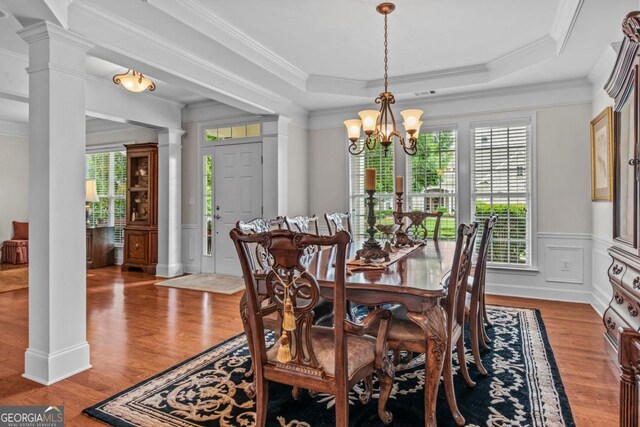 1000 Deep Water Way, Greensboro, GA 30642 - dining room with a chandelier, ornamental molding, wood finished floors, ornate columns, and a tray ceiling
