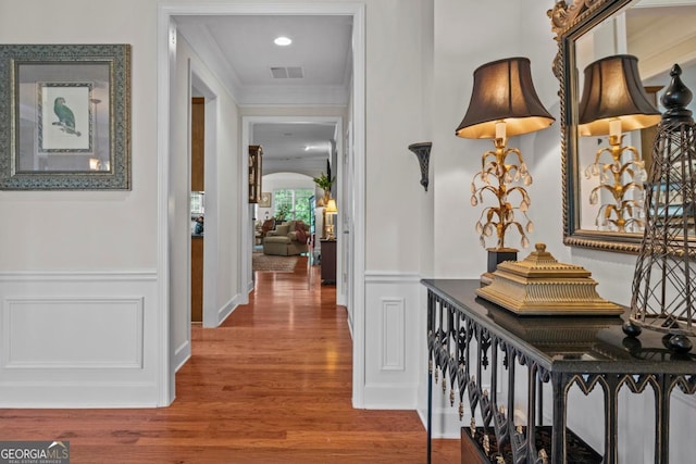 1000 Deep Water Way, Greensboro, GA 30642 - hallway with crown molding, wood finished floors, a wainscoted wall, and a decorative wall
