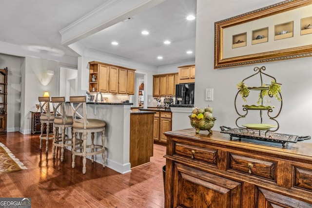 1000 Deep Water Way, Greensboro, GA 30642 - kitchen with open shelves, freestanding refrigerator, dark countertops, a peninsula, and a kitchen bar