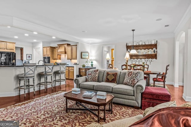 1000 Deep Water Way, Greensboro, GA 30642 - living room with light wood finished floors, arched walkways, crown molding, recessed lighting, and baseboards