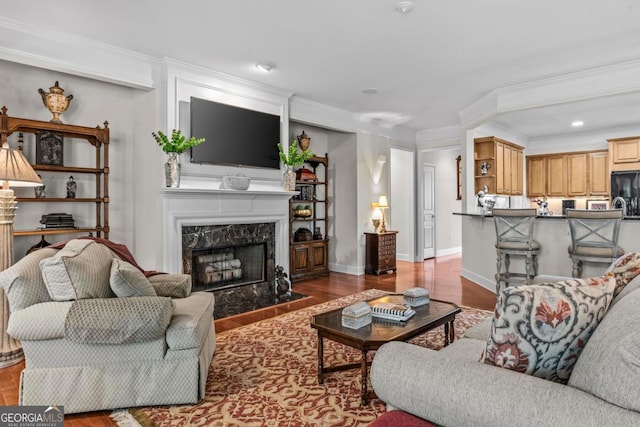 1000 Deep Water Way, Greensboro, GA 30642 - living room with a premium fireplace, wood finished floors, crown molding, baseboards, and recessed lighting